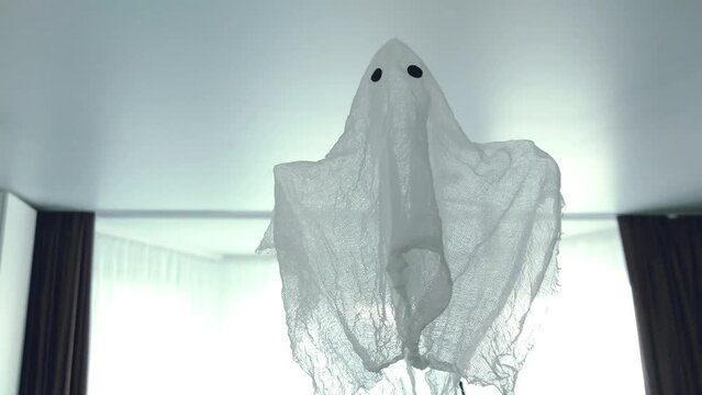 A white ghost flying in the room during the day