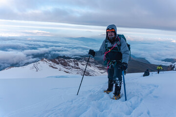 Fototapeta na wymiar Close up hiker portrait on snowfield and mountain background