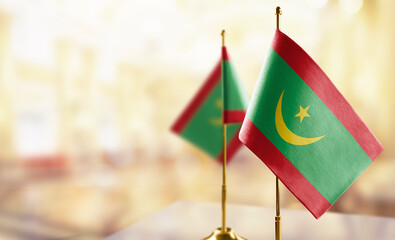 Small flags of the Mauritania on an abstract blurry background