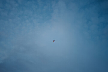 small minimalistic airplane flying high in the blue sky