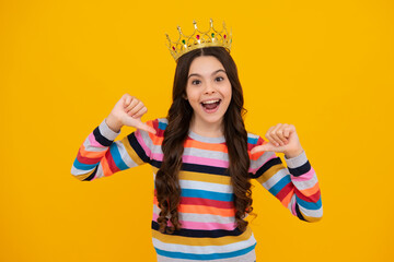 Amazed teenager. Portrait of ambitious teenage girl with crown, feeling princess, confidence. Child princess crown on isolated studio background. Excited teen girl.