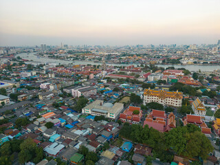 Aerial view Bangkok city buddhist temple with river sunset sky