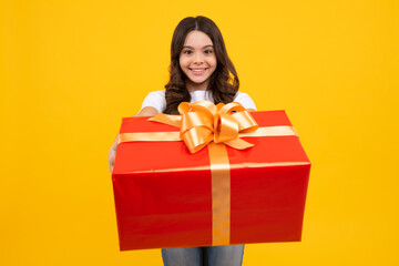 Child with gift present box on isolated background. Presents for birthday, Valentines day, New Year or Christmas. Happy teenager, positive and smiling emotions of teen girl.