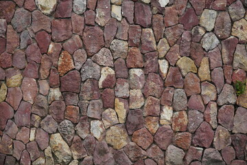 Natural stone wall built from regional red Amazon sandstones on the banks of the Amazon River in the Ponta Negra district of Manaus, Brazil.