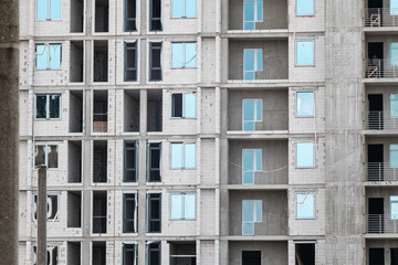 Multistory new residential white brick building facade construction site, architecture details pattern