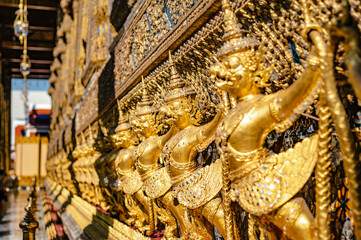 Golden Garuda statues surrounding the temple of Wat Phra Kaew, Bangkok, Thailand