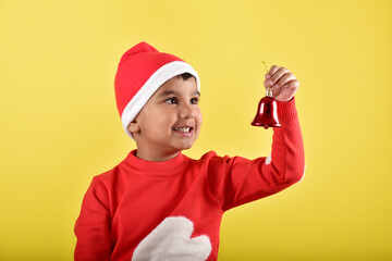 Child boy wearing santa cap and holding decorative things for christmas  © Karan