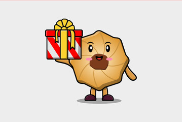 Cute cartoon Cookies character holding gift box in vector icon illustration