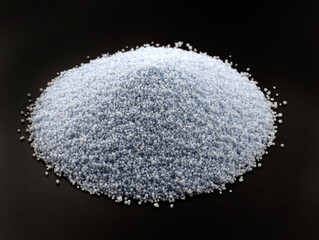 Palm wax for making candles on a black background. Blue Wax for bulk candles. A slide of palm wax granules close-up.