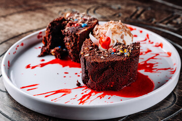 Chocolate Brownie cake with Vanilla Ice Cream on black plate