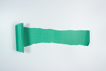 Torn sheet of green paper with copy space on white background
