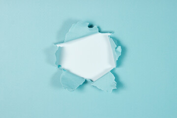 Torn sheet of blue paper with copy space on white background