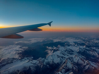 Fototapeta na wymiar Plane Window View over Mountains