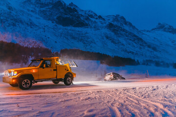 The roadside assistance service pulling the car out of the canal. An incident on a frozen Scandinavian road.