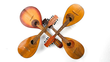 Four crossed vintage mandolins. Isolated on white background. Panoramic photo.