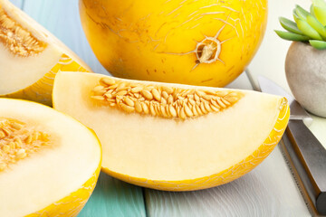 sliced yellow melon on wood background