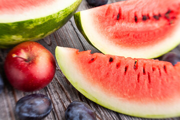 sliced watermelon on wood background