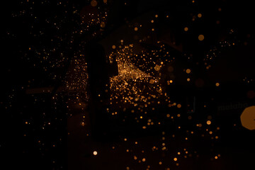 Steel processing. Metal sawing. Blade. Instrument in workshop. Lots of sparks. Lights in dark.