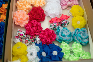 Obraz na płótnie Canvas Fabric bows. Handmade hair clips. Flowers from fabric flaps. Hair ornament.
