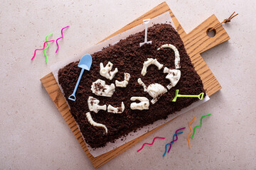 Chocolate cake with dinosaur bones for a child birthday