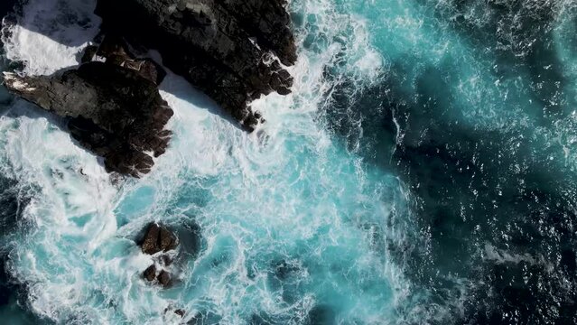 Aerial view of a waves breaking along the coast on a small bay along Socorro island, Revillagigedo archipelago, Colima, Mexico.