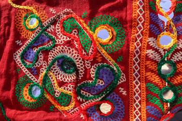Red fabric with embroidery background with mirror work 
