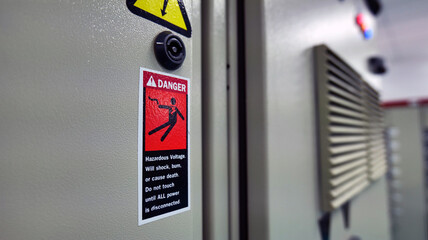 Warning signs, be careful of electric shocks attached to the electric control cabinet. Warning to...