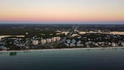 The final moments of light on Bonita Beach in Bonita Springs, FL as the sunsets over the Gulf of...