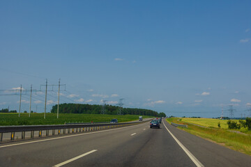 Highway wide road, transport and blue sky with clouds on a summer day