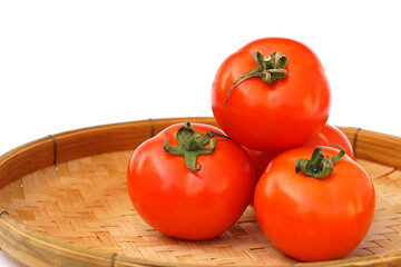 Fresh red ripe tomatoes in bamboo baskets on white background. soft and selective focus. 