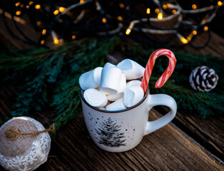 hot Christmas drink with marshmallow on wooden table