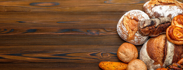 Homemade freshly baked bread. Wood rustic table, board. Bakery and baked goods bars, baguette,...