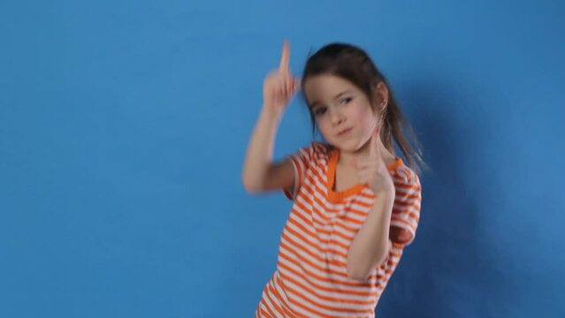 a little girl is dancing merrily on a blue background