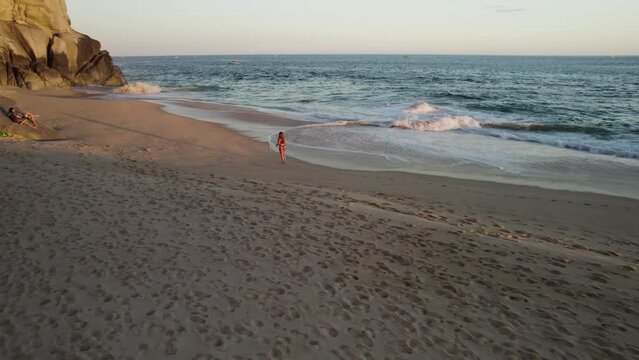 Aerial view of a person walking on the beach at Playa del Divorcio, Cabo San Lucas, Baja California, Mexico.