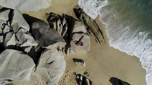Aerial view of people relaxing on the rocks at Playa del Divorcio, Cabo San Lucas, Baja California, Mexico.