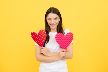 Beautiful amazing woman cuddle paper card heart shape, dreamy isolated on yellow background. Love concept.