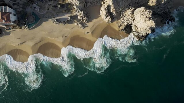 Aerial view of waves breaking on the shoreline at Playa del Divorcio, Cabo San Lucas, Baja California, Mexico.