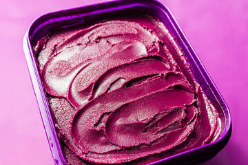 Açaí pot over purple surface, traditional brazilian food.