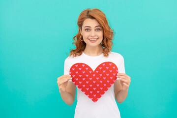 happy redhead woman hold red heart on blue background