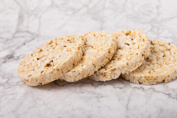 Rice cakes on a white marble background. Close-up. Healthy food. Diet food.