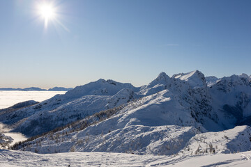 Winter mountains covered with snow landscape over clouds