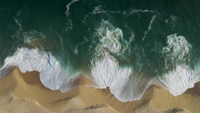 Aerial view of waves breaking on the shoreline at Playa del Divorcio, Cabo San Lucas, Baja California, Mexico.