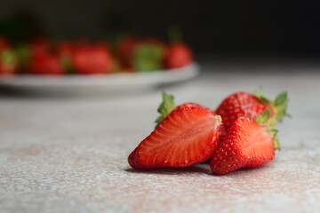 Fresh ripe delicious strawberries on the table on an abstract background	