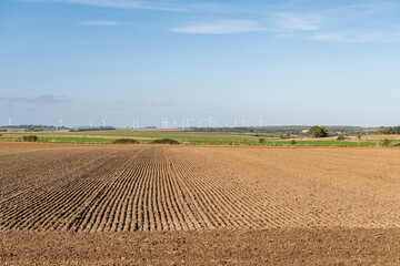 Flat farmland with distant wind turbines at Ligescourt in Northern France