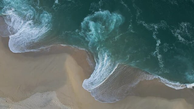 Aerial view of waves breaking on the shoreline at Playa del Divorcio, Cabo San Lucas, Baja California, Mexico.