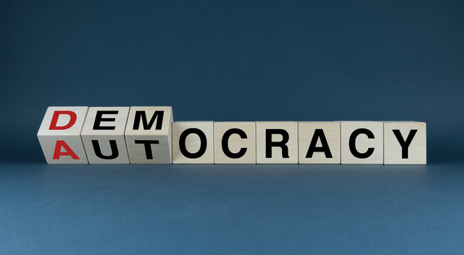 Democracy or Autocracy. The cubes form the words Democracy or Autocracyr