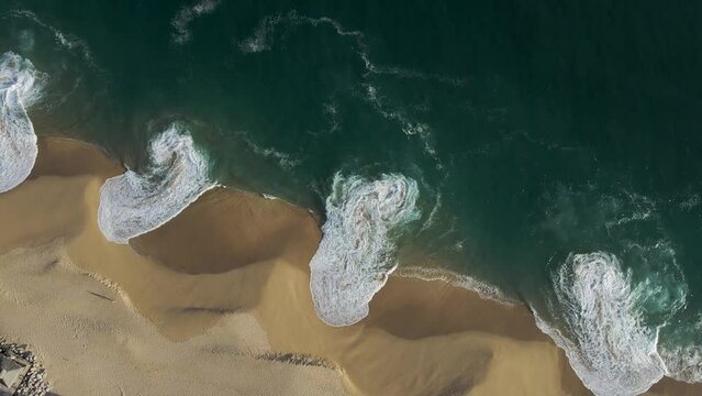 Aerial view of waves breaking on the shoreline at Playa del Divorcio, Cabo San Lucas, Baja California, Mexico.