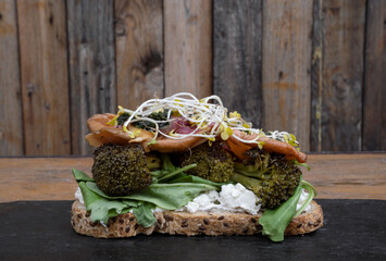 Healthy cuisine. Closeup view of a sourdough bread bruquette with grilled oyster mushrooms, bean...