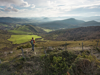 Hiker contemplating the Pamplona Basin from the top of Santa Barbara. Juslapeña