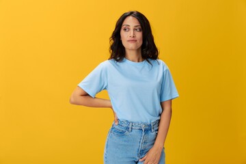 Woman signal smile with teeth emotion portrait in blue t-shirt on yellow background, hands up, surprise, lifestyle, copy space